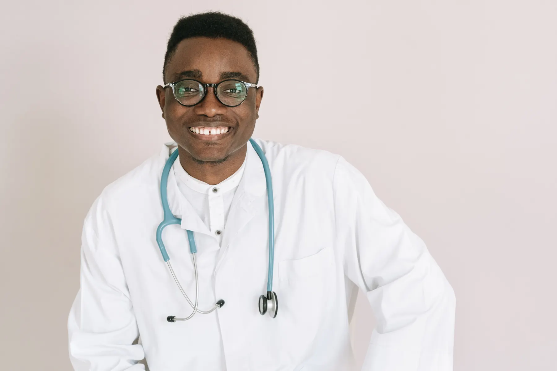 Smiling physician in a white coat with a stethoscope