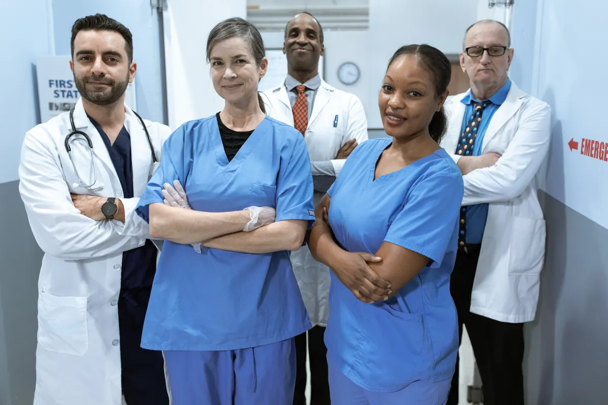 Physicians and nurses standing together in a hospital corridor